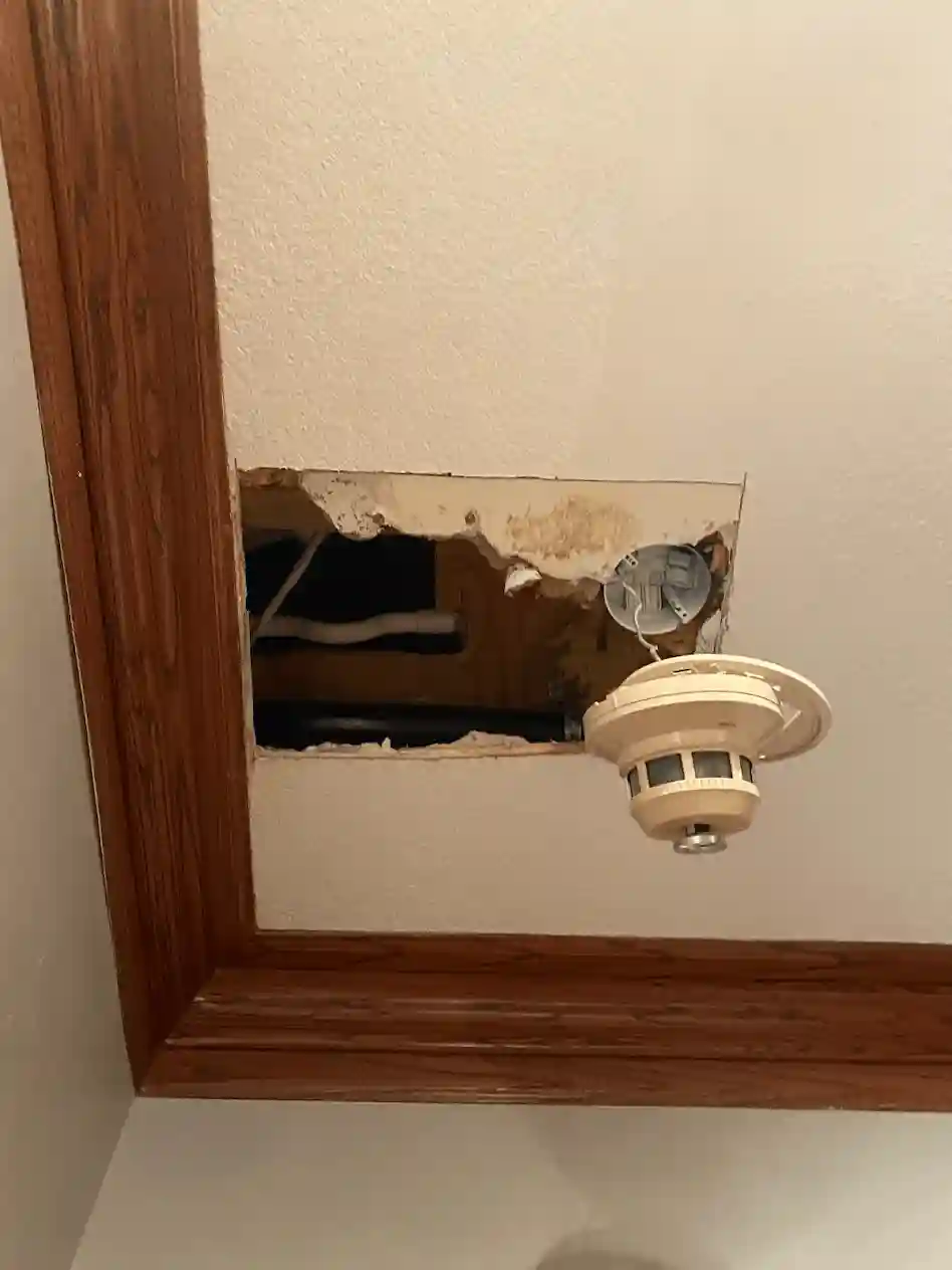 Drywall hole damage before repair in Kansas City home